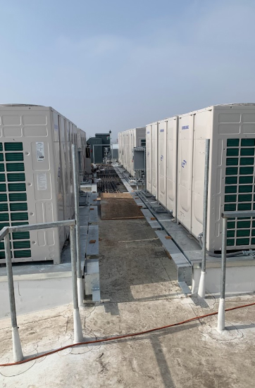 Twin rows of VRF condensers with engineered service walkway on a commercial roof